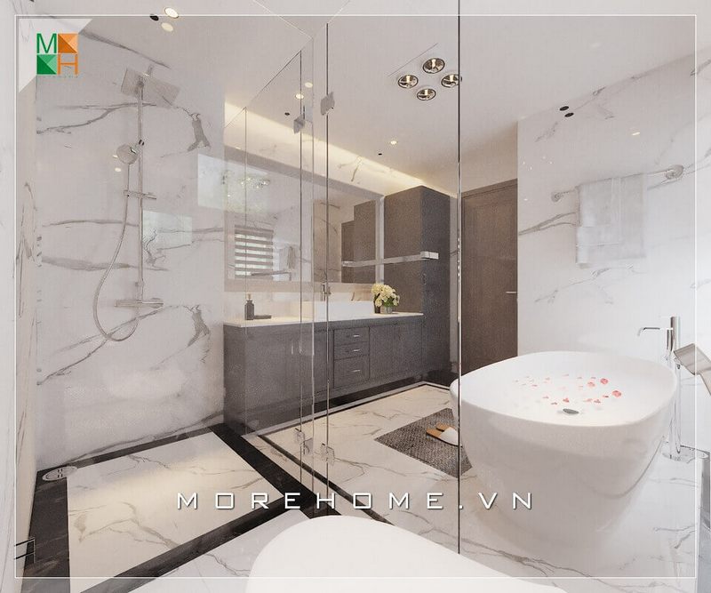 Với mẫu phòng tắm có diện tích lớn có thể thiết kế vách tắm bằng kính cường lực để chia thành các khu vực như khu vực tắm đứng, khu vực vệ sinh, khu vực tắm bồn và khu tủ lavabo, vừa giúp ngăn nước và giữ sàn khô ráo mà vẫn có sự liên kết trong không gian phòng tắm